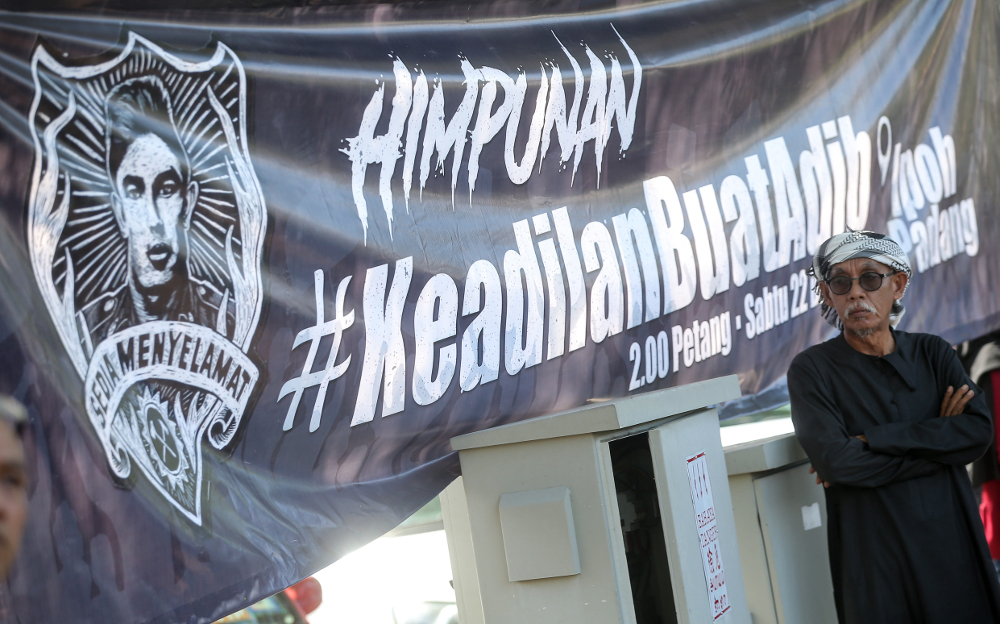 A banner is seen at a gathering of Malay groups in Ipoh to demand justice for Muhammad Adib Mohd Kassim December 22, 2018. u00e2u20acu201d Picture by Farhan Najib
