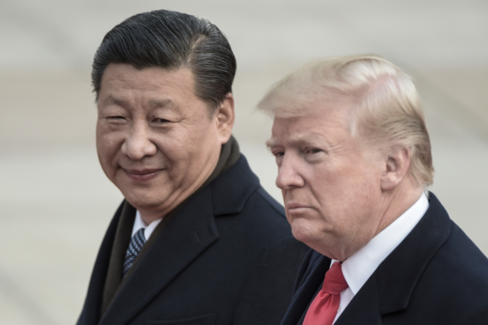 In this file picture taken on November 9, 2017, Xi and Trump attend a welcome ceremony at the Great Hall of the People in Beijing.-- AFP pic