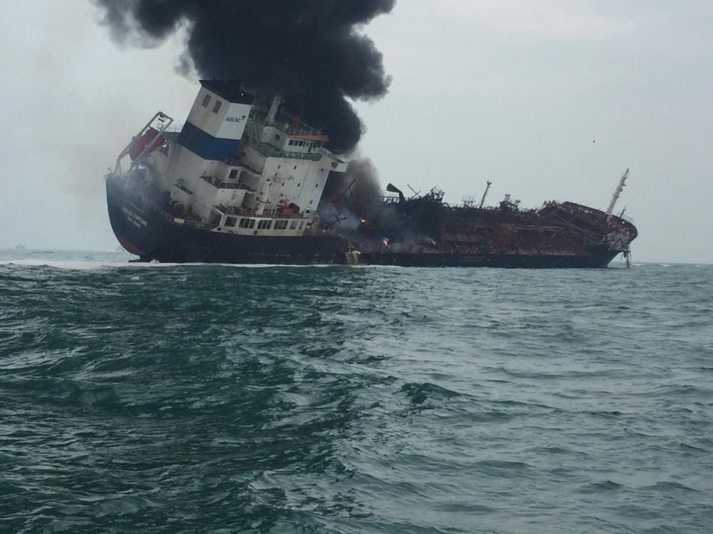 The coastal oil tanker is seen listing with black smoke pouring from the hull. Rescue operations were going on about one nautical mile south of Lamma Island. u00e2u20acu201d Picture from Facebook/Hong Kong Police