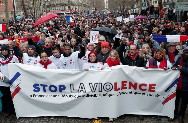 Opponents to the ,yellow vests, violent behaviour, take part in a demonstration by the ,red scarves, movement in Paris, France, January 27, 2019. The banner reads: ,Stop the violence,. REUTERS/Benoit Tessier
