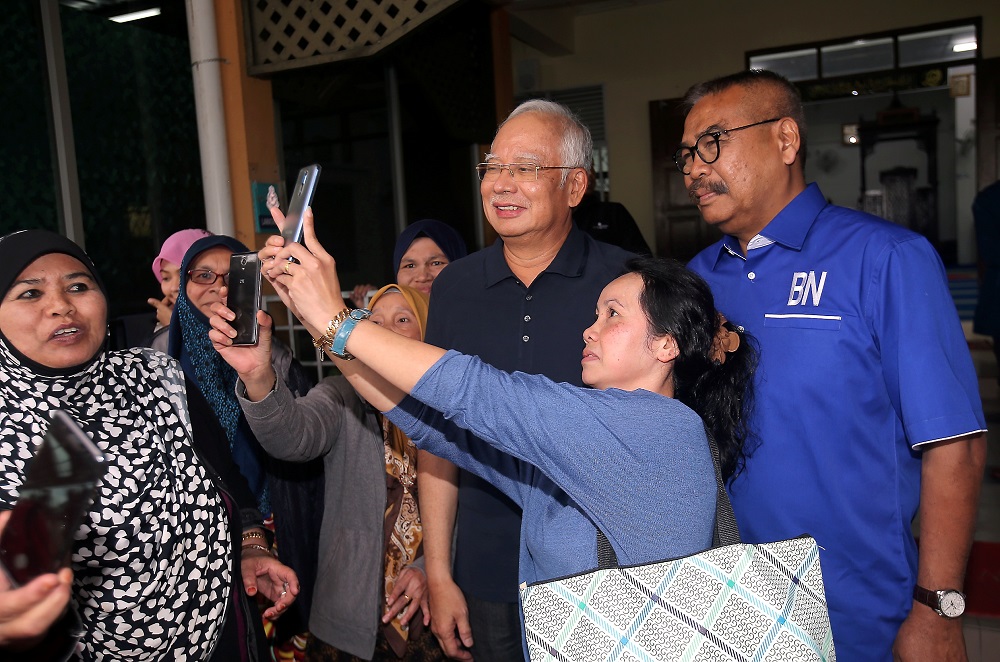 Datuk Seri Najib Razak take photos with members of the public upon his arrival at the Masjid Kampung Raja in Cameron Highlands January 17, 2019. u00e2u20acu201d Picture by Farhan Najib