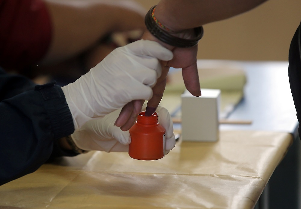 An Election Commission officer dips a voteru00e2u20acu2122s finger in indelible ink at the polling station at SJK (C) Bertam Valley in Cameron Highlands January 26, 2019. u00e2u20acu201d Picture by Farhan Najib