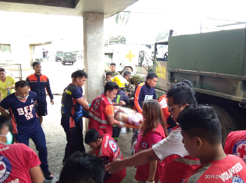 Members of the Philippine Red Cross carry a casualty after a church bombing attack in Jolo, Philippines January 27, 2019 in this image obtained from social media. u00e2u20acu201d REUTERS PIC