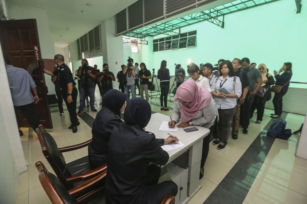 Members of the media gather at the entrance of a courtroom at the Shah Alam Sessions Court January 18, 2019. u00e2u20acu201d Picture by Yusof Mat Isa