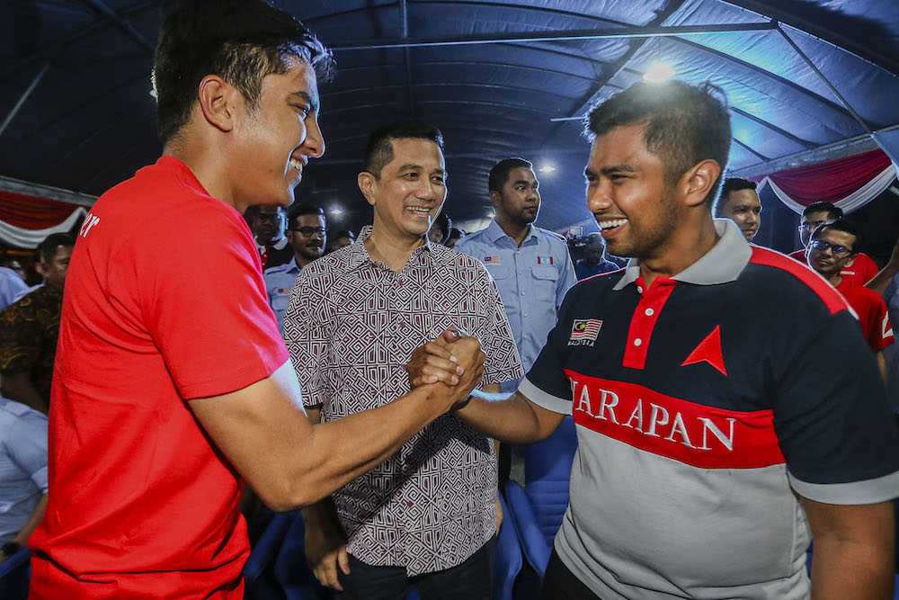 Syed Saddiq Abdul Rahman (left) shakes hands with Pakatan Harapanu00e2u20acu2122s Semenyih candidate Muhammad Aiman Zainali (right), as Datuk Seri Azmin Ali looks on, in Semenyih February 15, 2019. u00e2u20acu201d Picture by Hari Anggara
