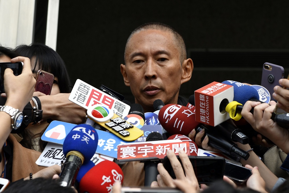 Film director Doze Niu (centre), also known as Niu Chen-zer, is surrounded by the press outside a police station in Taipei December 7, 2018. u00e2u20acu201d AFP pic  
