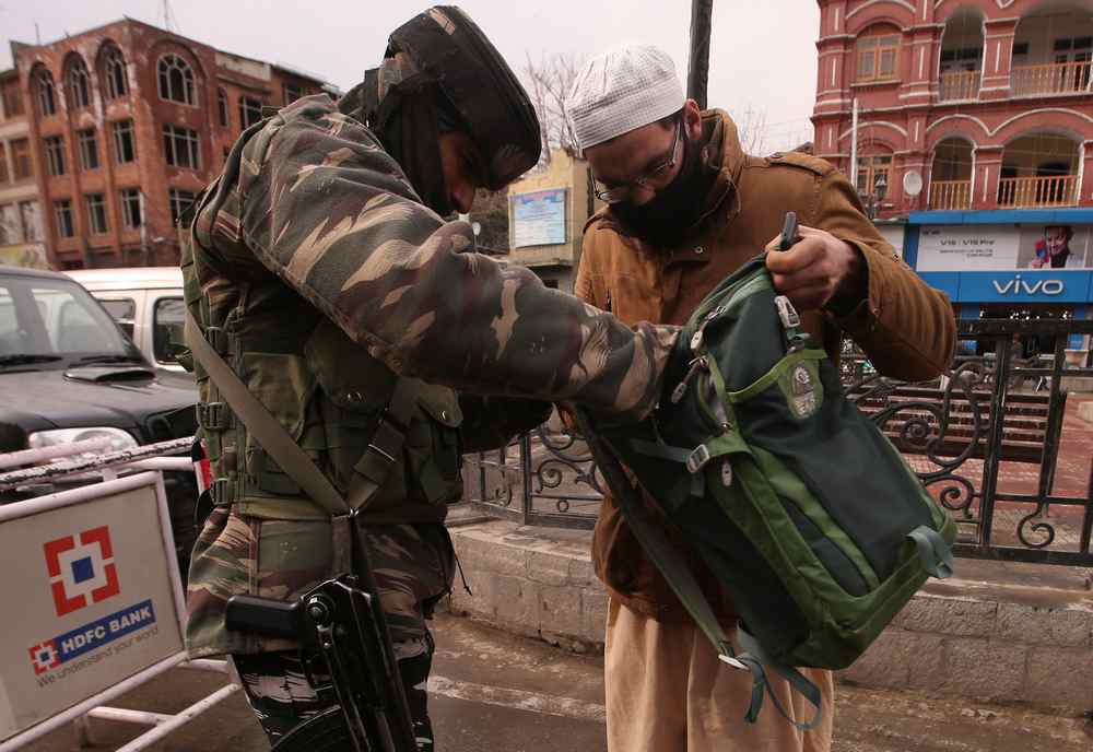An Indian Central Reserve Police Force (CRPF) officer checks the bag of a man in Srinagar February 25, 2019. u00e2u20acu201d Reuters pic