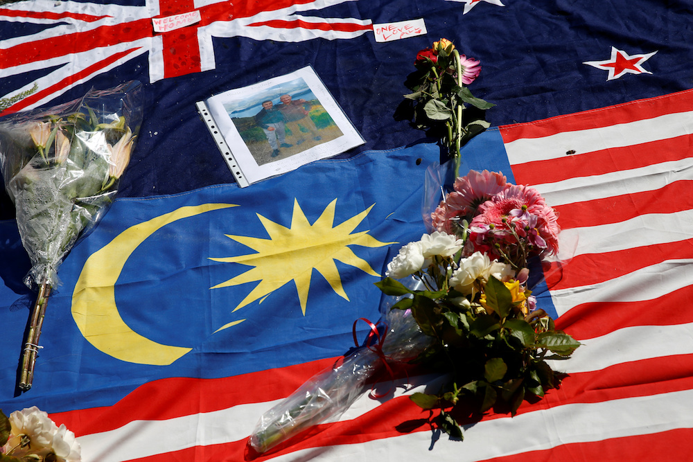 Flowers, messages and flags of New Zealand and Malaysia are seen at the memorial site for the victims of Fridayu00e2u20acu2122s shooting, outside Masjid Al Noor mosque in Christchurch, New Zealand March 19, 2019. u00e2u20acu201d Reuters pic