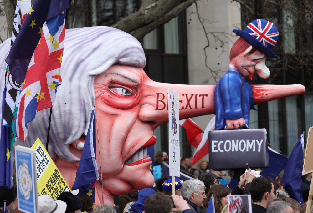 A puppet head of Britainu00e2u20acu2122s Prime Minister Theresa May spearing a representation of the British Economy at a rally by the pro-European Peopleu00e2u20acu2122s Vote campaign for a second EU referendum in London March 23, 2019. u00e2u20acu201d AFP pic