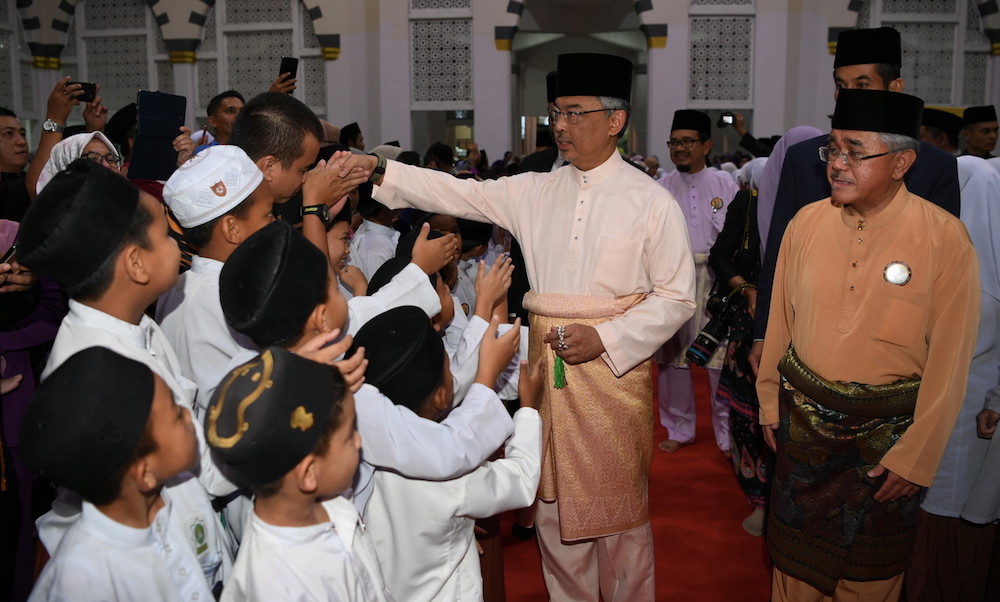 Yang di-Pertuan Agong Sultan Abdullah Ahmad Shah greets children before a Yasin recital, tahlil and tazkirah ceremony at the Kota Kinabalu City Mosque March 7, 2019. u00e2u20acu201d Bernama pic