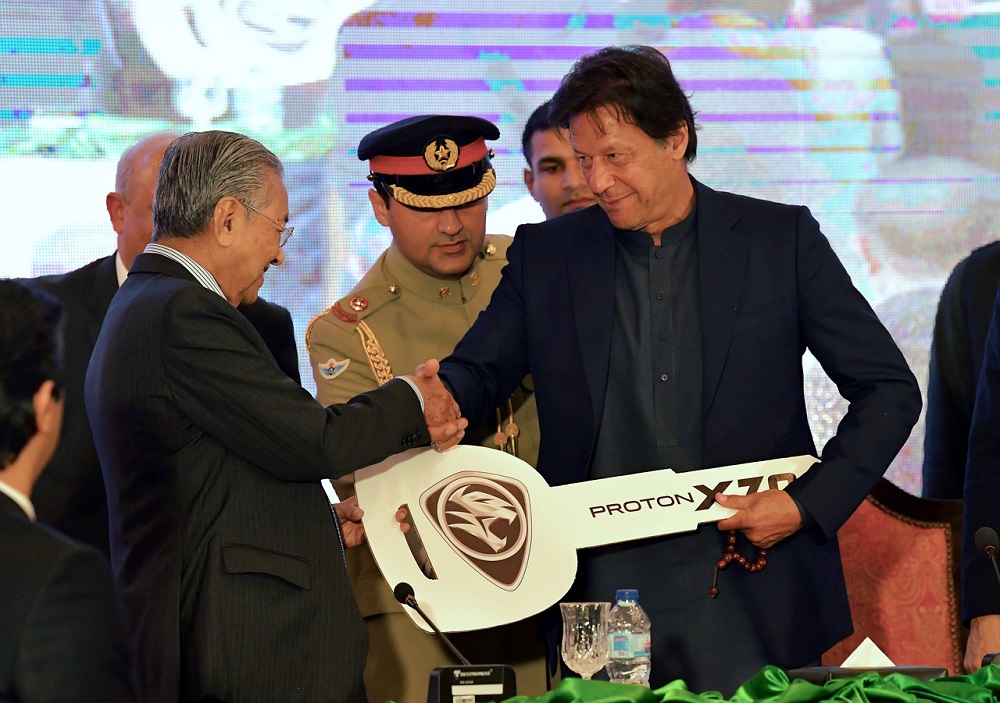 Prime Minister Tun Dr Mahathir Mohamad hands over a replica of a Proton X70 key to his Pakistani counterpart Imran Khan at the symbolic groundbreaking ceremony for Protonu00e2u20acu2122s manufacturing assembly plant Pakistan March 22, 2019.  Bernama  pic