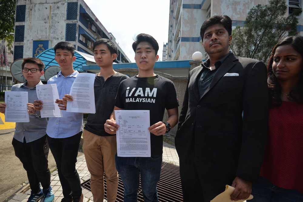 Universiti Malaya Association of New Youth (Umamy) president Wong Yan Ke and other UM students pose with the police report in front of Pantai police station March 23, 2019. u00e2u20acu201d Picture by Shafwan Zaidon