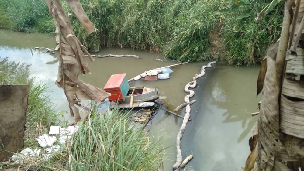 Part of the Sungai Kim Kim river in Pasir Gudang that is undergoing a clean-up today. Oil booms have been fitted to stop the oily substance from floating further down river. u00e2u20acu201d Picture courtesy of the Johor Fire and Rescue Department