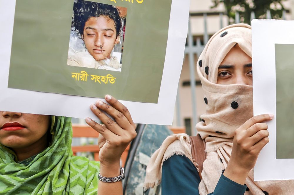 In this photo taken April 12, 2019 Bangladeshi women hold placards and photographs of schoolgirl Nusrat Jahan Rafi at a protest in Dhaka, following her murder by being set on fire after she had reported a sexual assault. u00e2u20acu201d AFP pic