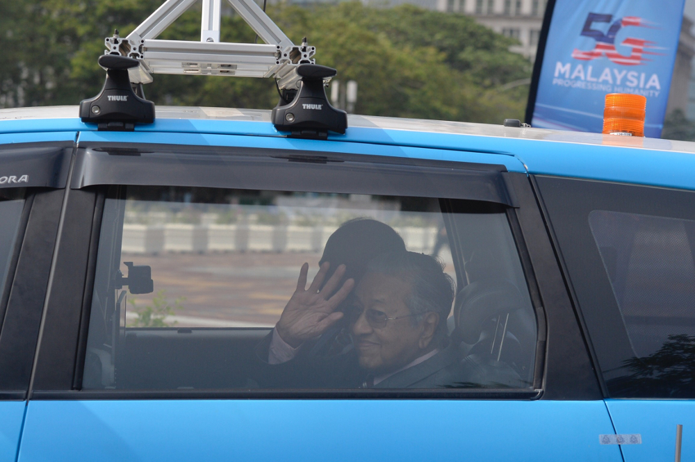 Prime Minister Tun Dr Mahathir Mohamad with Communication and Multimedia Minister Gobind Singh Deo ride the 5G autonomous car during the launch of Malaysiau00e2u20acu2122s 5G network in Putrajaya April 18, 2019. u00e2u20acu201d Picture by Mukhriz Hazim