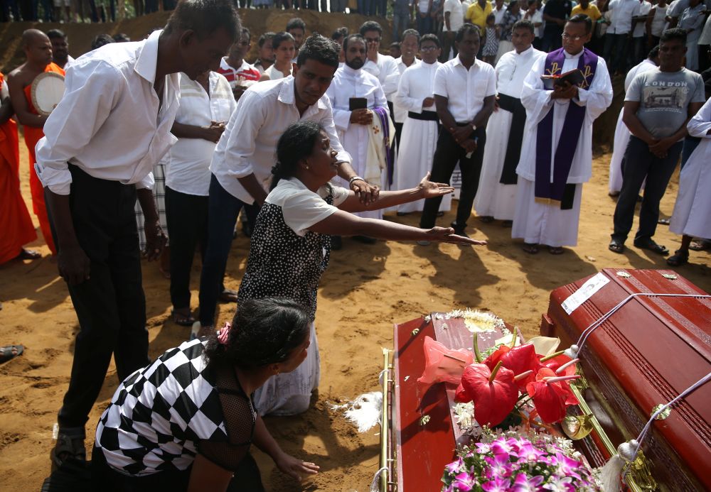 Women react during a mass burial of victims, two days after a string of suicide bomb attacks on churches and luxury hotels across the island on Easter Sunday, at a cemetery near St Sebastian Church in Negombo, Sri Lanka April 23, 2019. u00e2u20acu201d Reuters pic