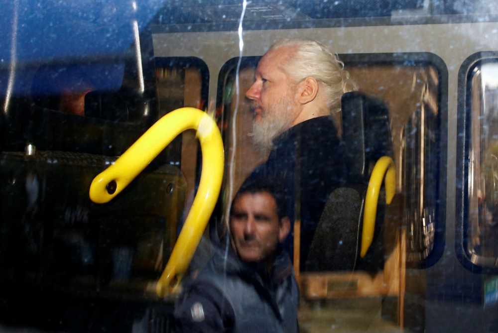 A man is reflected in a window of a police van as WikiLeaks founder Julian Assange is seen inside, after he was arrested, in London, Britain April 11, 2019. u00e2u20acu201d Reuters pic 