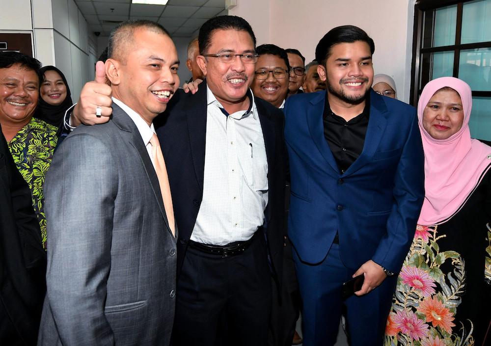 (From left) Amir Sharifuddin Abd Raub, Datuk Abdul Latif Bandi and Ahmad Fauzan Hatim Abd Latif pose for pictures at the Sessions Court in Johor Baru April 21, 2019. u00e2u20acu201d Bernama pic