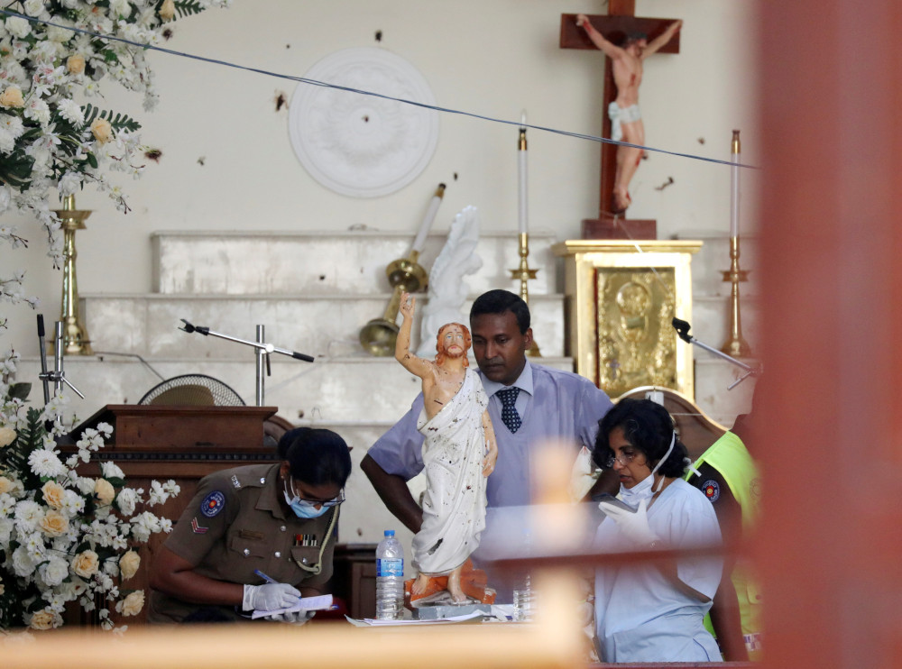 Police officers work at the scene at St Sebastian Catholic Church, after bomb blasts ripped through churches and luxury hotels on Easter, in Negambo, Sri Lanka April 22, 2019. u00e2u20acu201d Reuters pic  