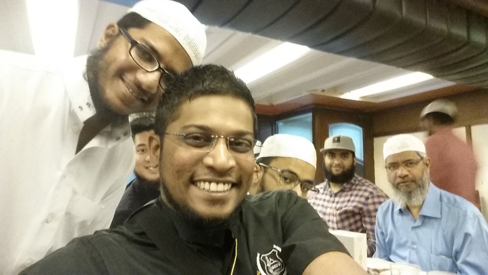 Zamri Vinoth (in black) is pictured during a meeting with controversial preacher Dr Zakir Naik (far right). u00e2u20acu201d Picture via Twitter