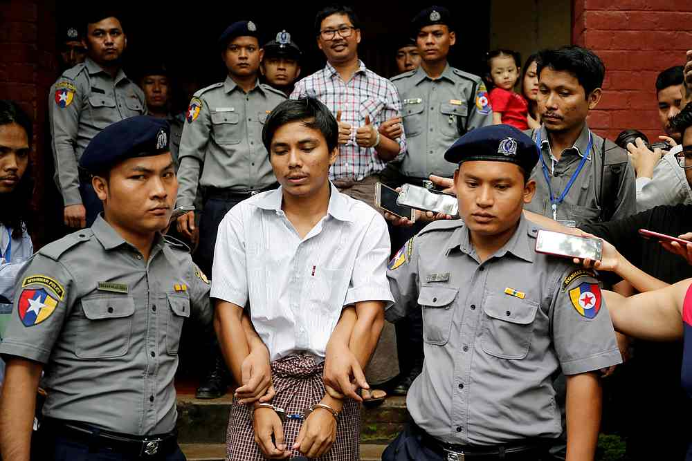 Detained Reuters journalist Kyaw Soe Oo and Wa Lone are escorted by police as they leave after a court hearing in Yangon, Myanmar August 20, 2018. u00e2u20acu201d Reuters pic