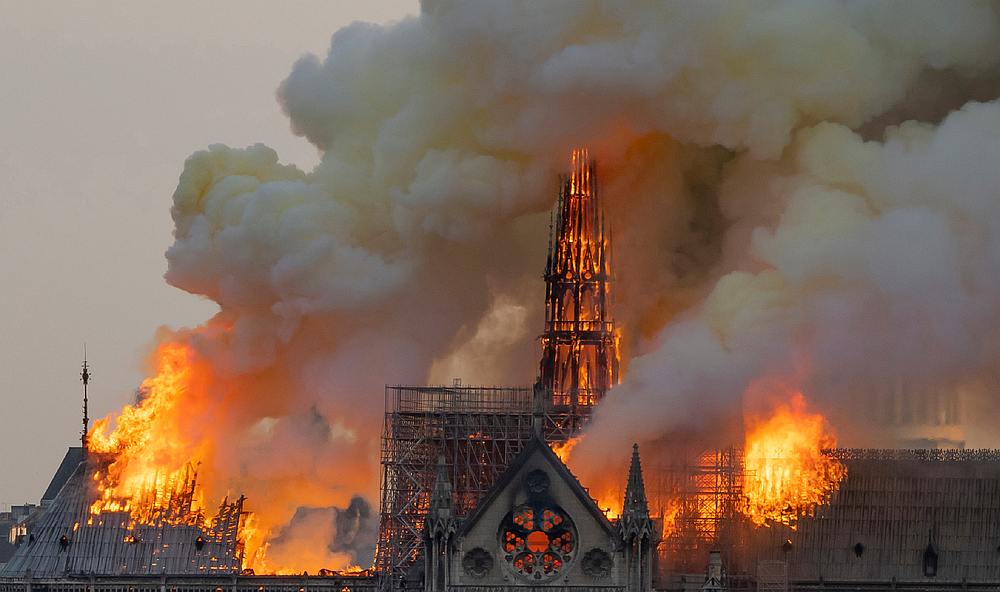 Smoke billows as flames burn through the roof of the Notre-Dame de Paris Cathedral April 15, 2019 u00e2u20acu201d AFP picn