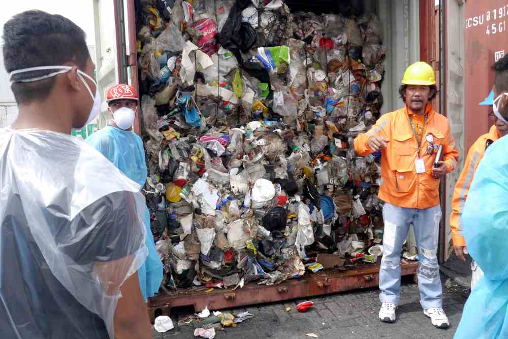 Philippine customs officials inspect cargo containers containing tonnes of garbage shipped by Canada at Manila port November 10, 2014. u00e2u20acu2022 Picture by BAN Toxics/Handout via Reuters