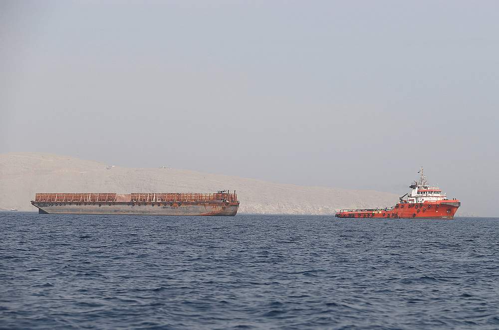 A tugboat moves cargo towards the Strait of Hormuz off the coast of Musandam province, Oman, July 20, 2018. u00e2u20acu201d Reuters pic