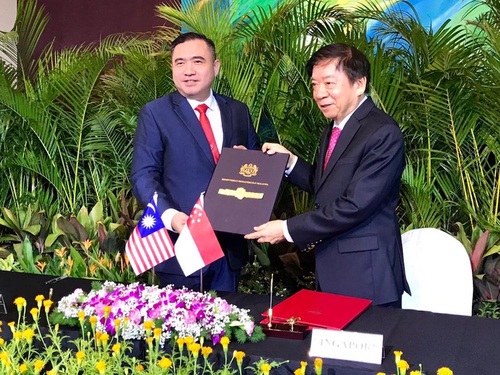 Transport Minister Anthony Loke and his Singapore counterpart Khaw Boon Wan are seen during the signing of the supplementary agreement for the RTS suspension between the two countries at the PSA Building in Singapore May 21, 2019. u00e2u20acu201d Picture by Ben Tan