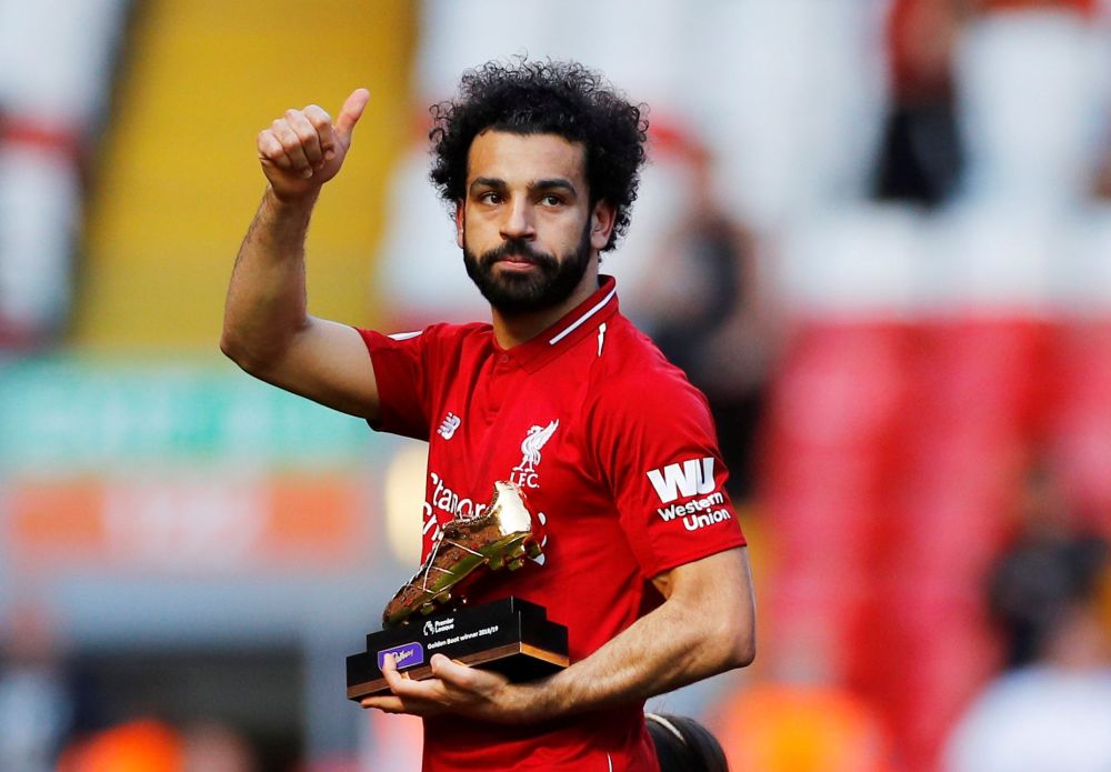 Liverpool's Mohamed Salah gestures to the fans as he holds a trophy for winning the Premier League Golden Boot award after the match against Wolverhampton Wanderers. u00e2u20acu201d Reuters pic