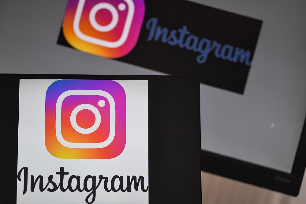 Logos of US social network Instagram are displayed on the screen of a computer and a smartphone, in Nantes May 2, 2019. u00e2u20acu201d AFP pic