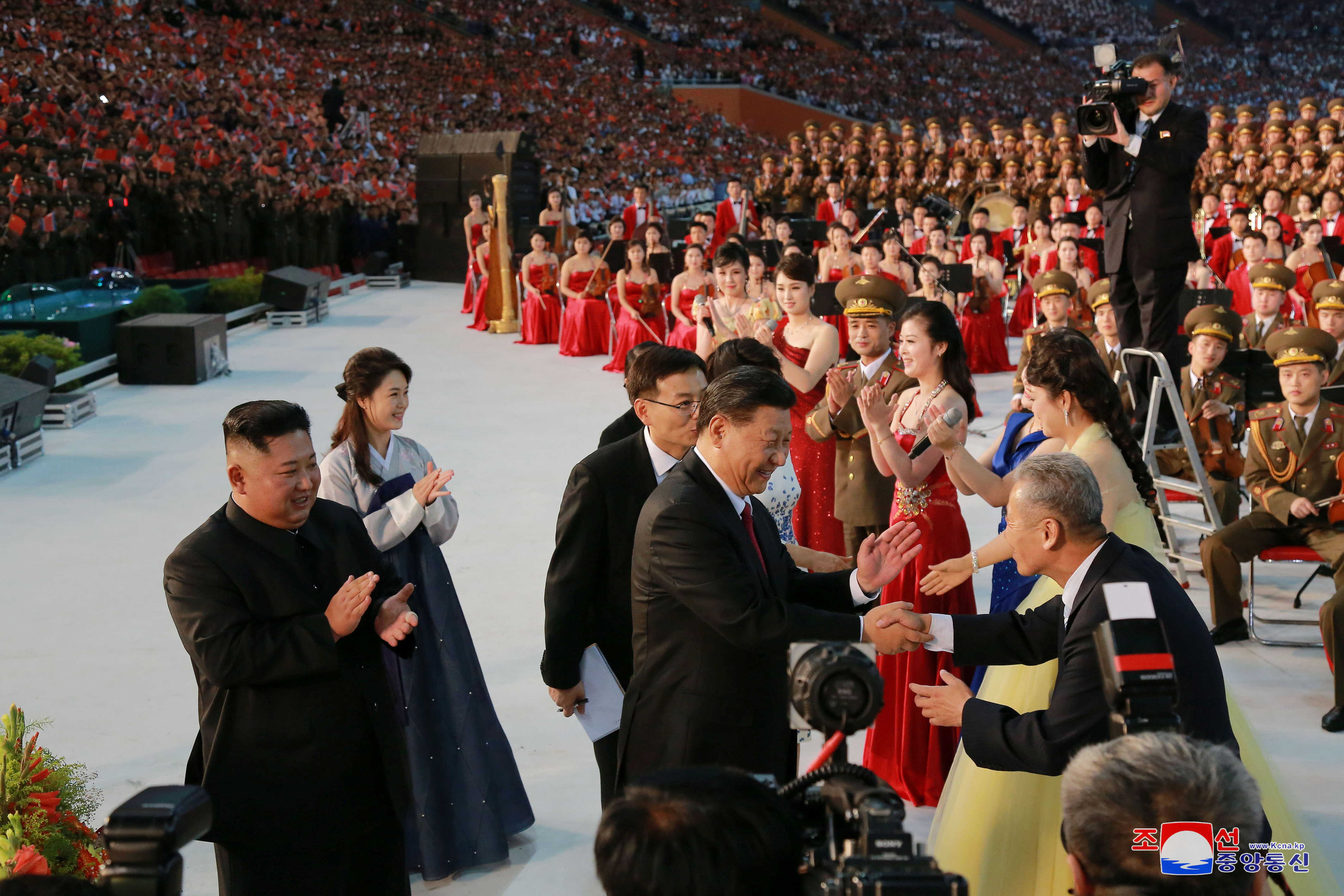 演出结束后，习近平和妻子彭丽媛与金正恩伉俪一起步上舞台，再次向朝鲜艺术家和群众致谢，并合影留念。-路透社-