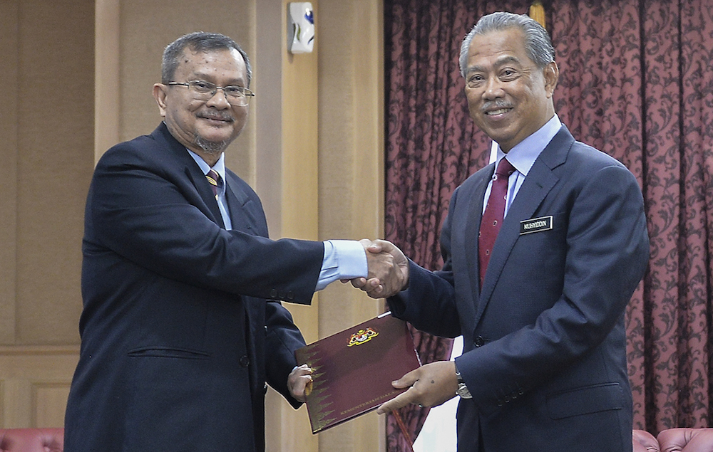 Tan Sri Muhyiddin Yassin and Datuk Abdul Rahim Uda are seen during appointment of the special task force on the enforced disappearances of pastor Raymond Koh and Amri Che Mat in Putrajaya June 26, 2019. u00e2u20acu201d Picture by Miera Zulyana