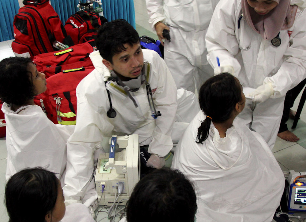 Emergency services staff attend to students with reported breathing difficulties at Sekolah Agama Taman Mawar in Pasir Gudang June 20, 2019. u00e2u20acu201d Bernama pic