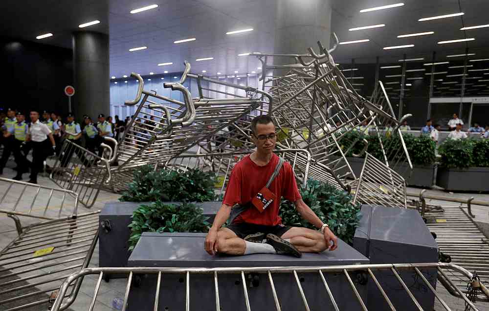 A man meditates amid clashes of demonstrators with riot police during a protest outside the Legislative Council in Hong Kong June 10, 2019. u00e2u20acu201d Reuters pic 