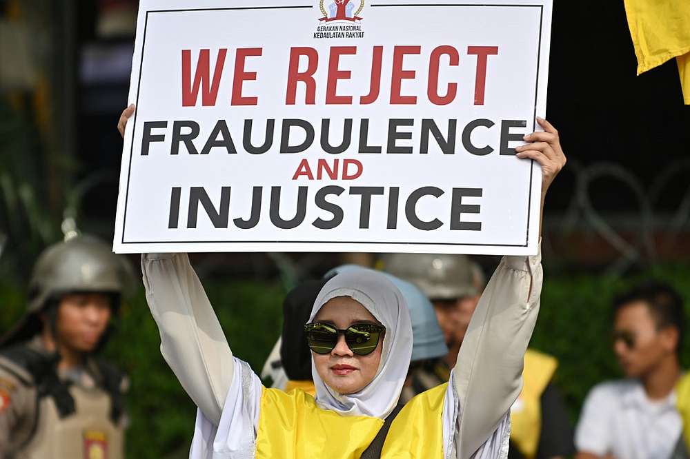 A protester displays a placard during a rally outside the constitutional court in Jakarta June 14, 2019. u00e2u20acu201d AFP pic 