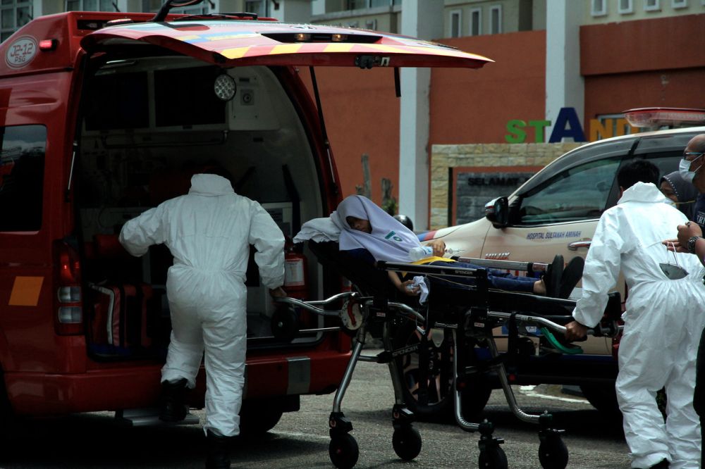 Emergency services staff attend to a student with reported breathing difficulties at Sekolah Menengah Kebangsaan Taman Nusa Damai in Pasir Gudang June 23, 2019. u00e2u20acu201d Bernama pic