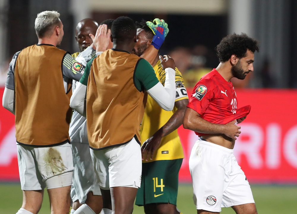 Egypt's Mohamed Salah looks dejected after the match as South Africa players celebrate, July 6, 2019. u00e2u20acu201d Reuters pic