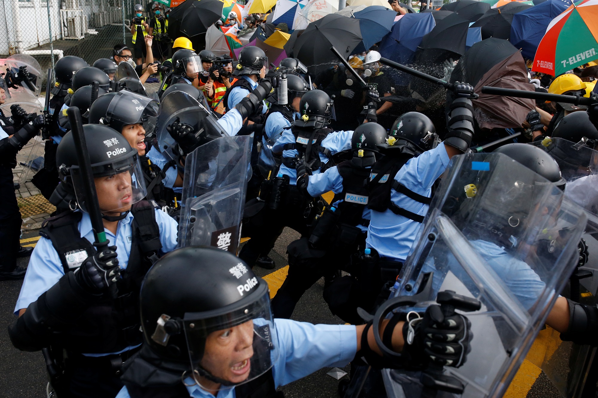Protesters try to break into the Legislative Council building where riot police are seen, during the anniversary of Hong Kong's handover to China in Hong Kong, China July 1, 2019. REUTERS/Tyrone Siu