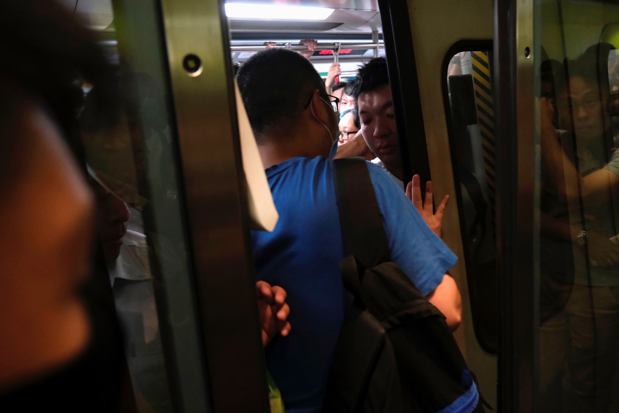 Anti-extradition bill demonstrators block a Mass Transit Railway (MTR) train in Hong Kong, China July 30, 2019. REUTERS/Tyrone Siu