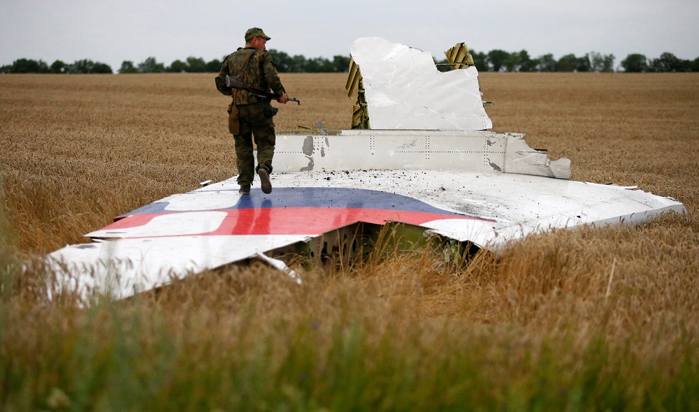 An armed pro-Russian separatist stands on part of the wreckage of the Malaysia Airlines Flight MH17 after it crashed near the settlement of Grabovo in the Donetsk region July 17, 2014. u00e2u20acu201d Reuters pic