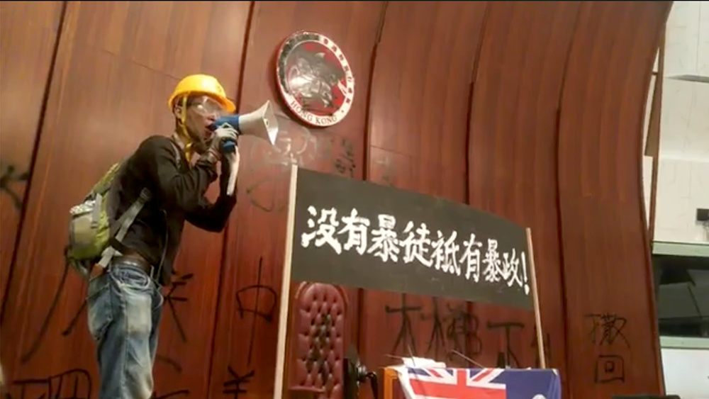 A protester uses a loudspeaker inside the Legislative Council building in Hong Kong July 1, 2019, in this still image taken from a video obtained by social media. u00e2u20acu201d Reuters pixnn