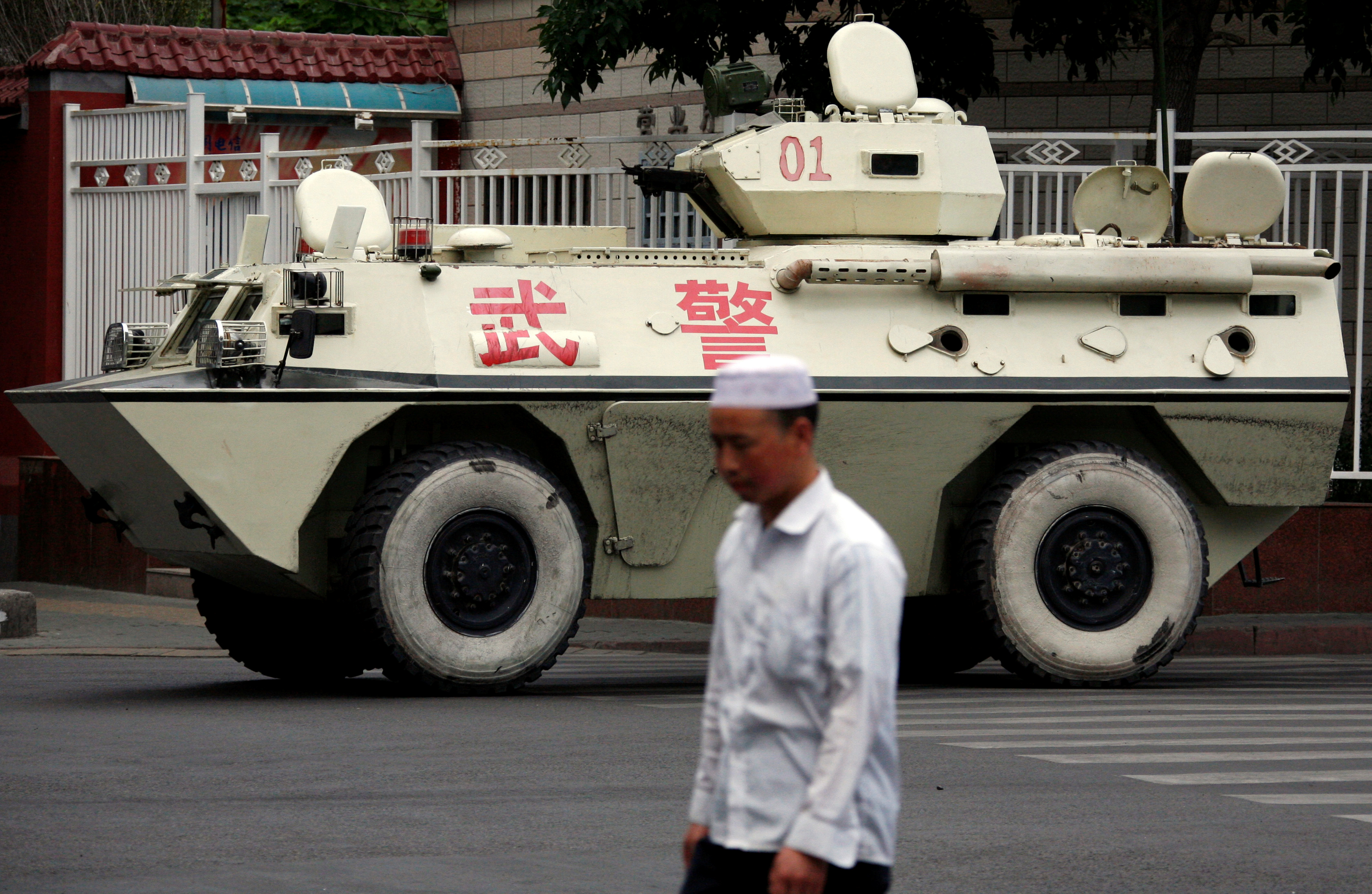 A local man walks past a Chinese armoured personnel carrier (APC) as it patrols the streets of Urumqi, Xinjiang Autonomous Region, in China July 6, 2009. u00e2u20acu201d Reuters pic