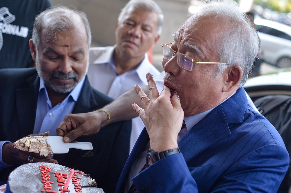 Datuk Seri Najib Razak is greeted with cheers and a chocolate cake for his 66th birthday at the lobby of the Kuala Lumpur Court Complex July 23, 2019. u00e2u20acu201d Picture by Mukhriz Hazim 