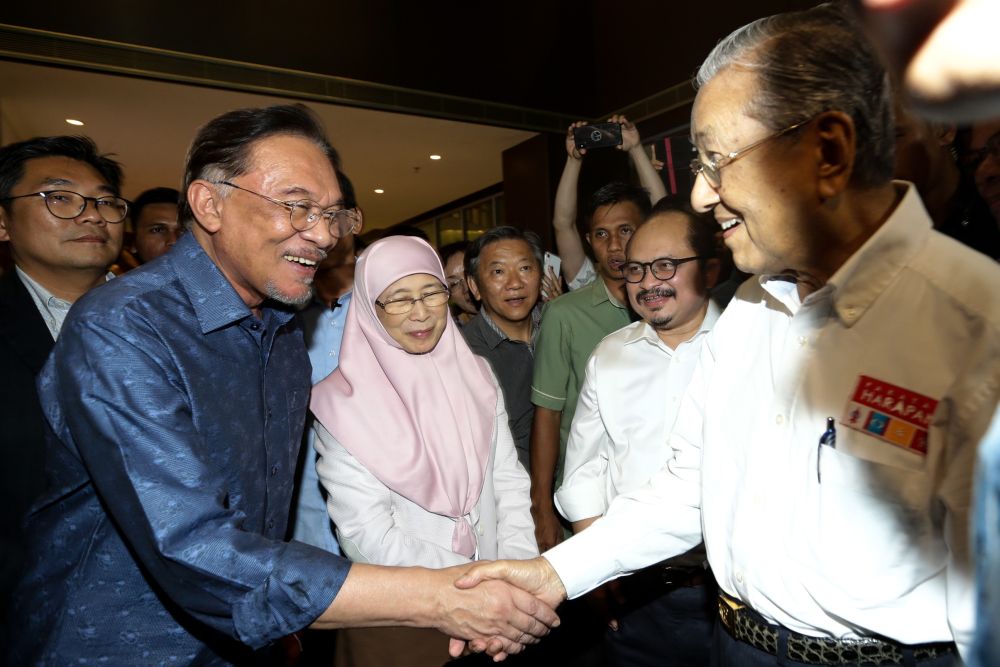 Datuk Seri Anwar Ibrahim (left) greets Tun Dr Mahathir Mohamad during PKRu00e2u20acu2122s retreat at the Lexis Hibiscus resort in Port Dickson July 19, 2019. u00e2u20acu201d Picture by Ahmad Zamzahuri