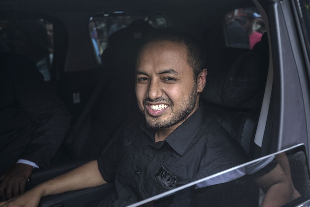 PKR Perak chief Farhash Wafa Salvador Rizal Mubarak (centre) is pictured leaving the Dang Wangi police station in Kuala Lumpur July 23, 2019. u00e2u20acu2022 Picture by Shafwan Zaidon