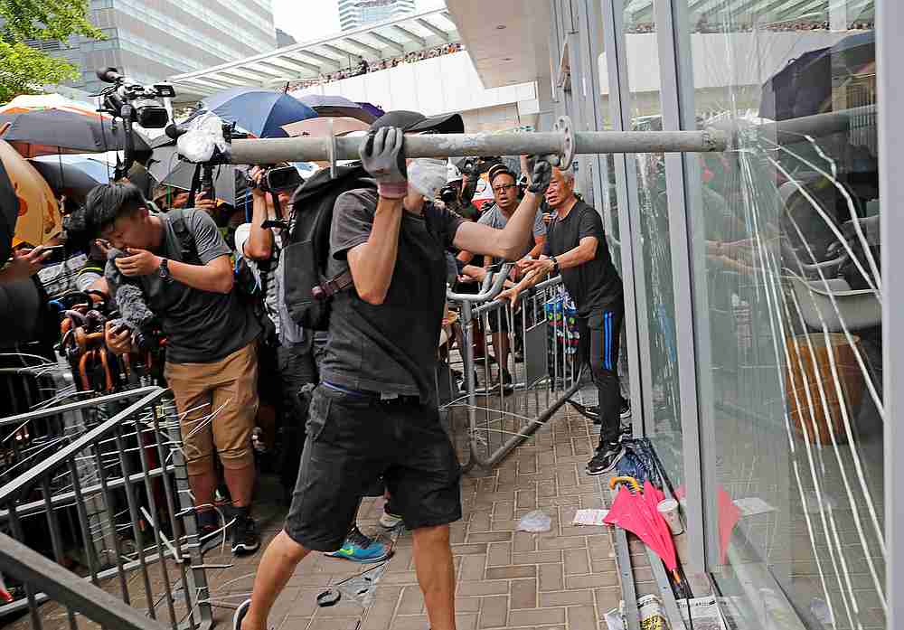 Protesters try to break into the Legislative Council building where riot police are seen, during the anniversary of Hong Kong's handover to China in Hong Kong, China July 1, 2019. 