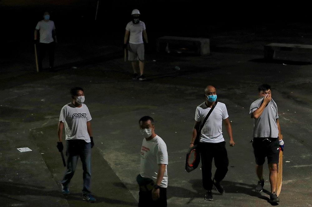 Men in white T-shirts with poles are seen in Yuen Long after attacking anti-extradition bill demonstrators at a train station in Hong Kong July 22, 2019. u00e2u20acu201d Reuters pic