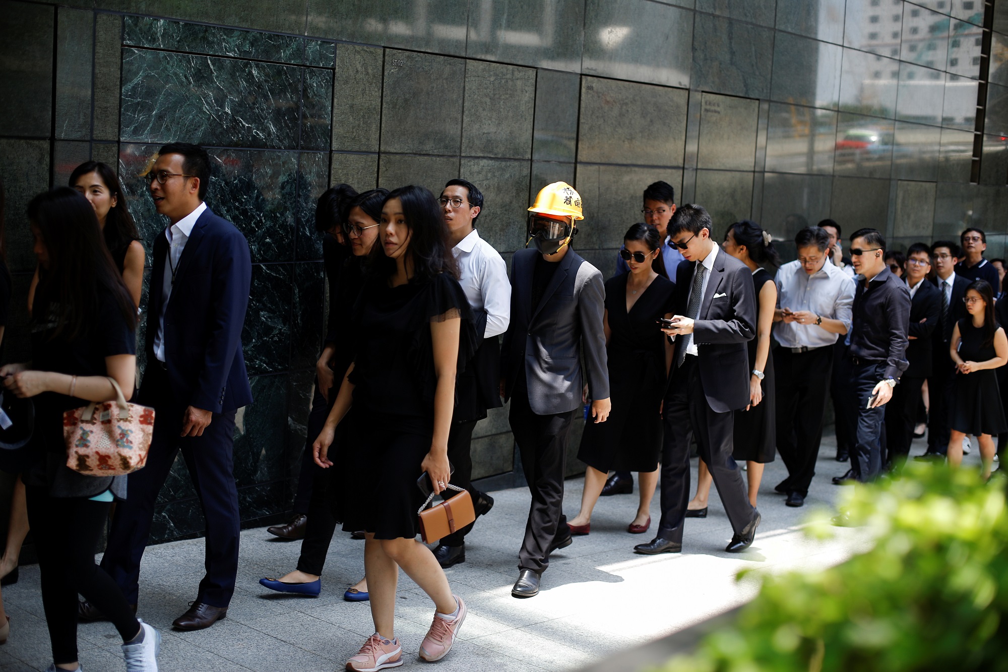 Lawyers and workers in Hong Kong's legal sector walk during a silent protest march to the Department of Justice in Hong Kong, China August 7, 2019. REUTERS/Thomas Peter