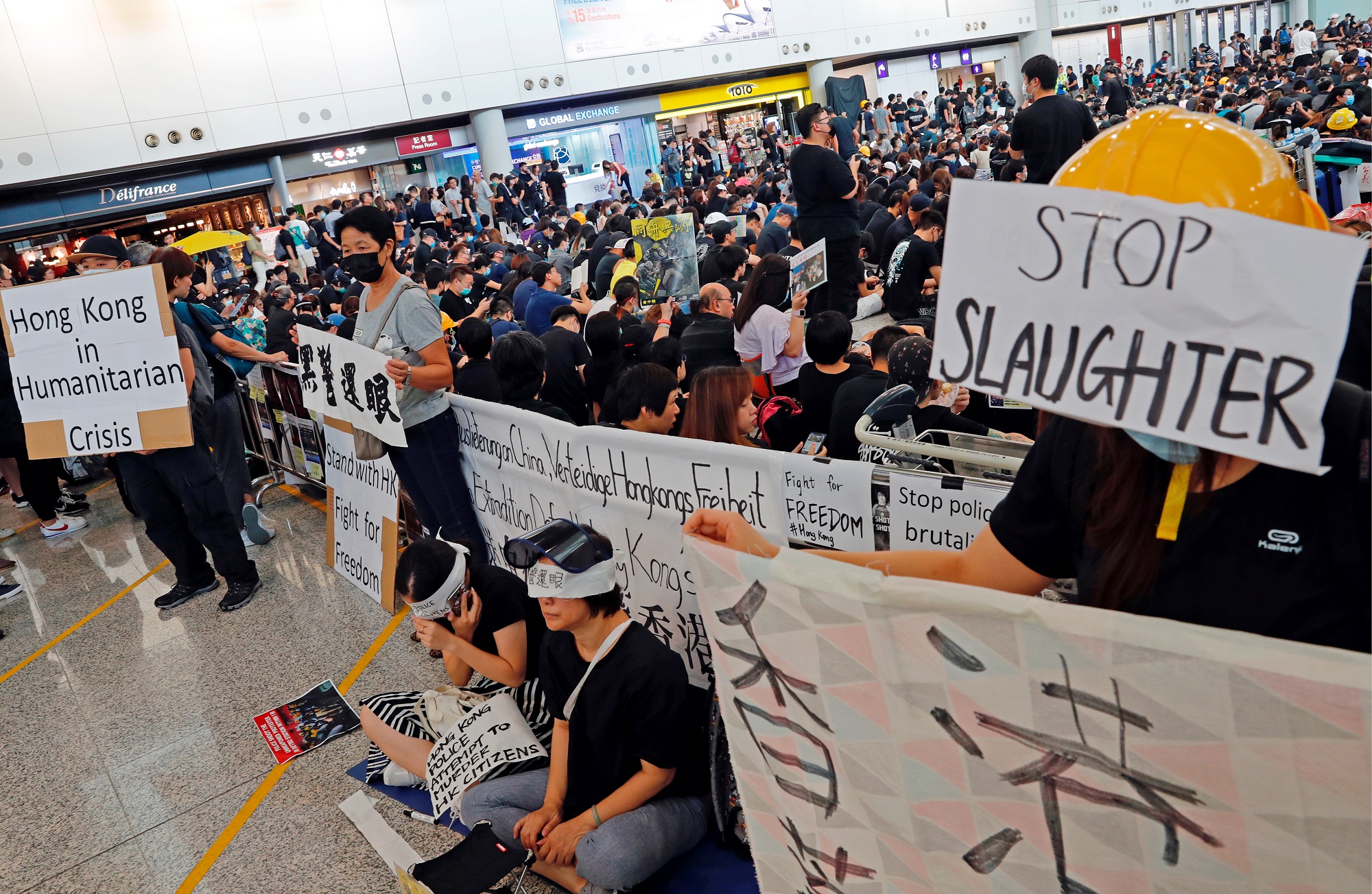 Anti-extradition bill protesters attend a mass demonstration after a woman was shot in the eye during a protest at Hong Kong International Airport, in Hong Kong, China August 12, 2019. REUTERS/Tyrone Siu